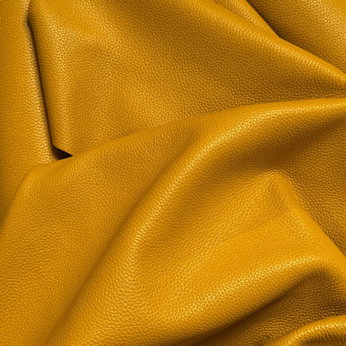 Close-up of yellow leather fabric with visible texture